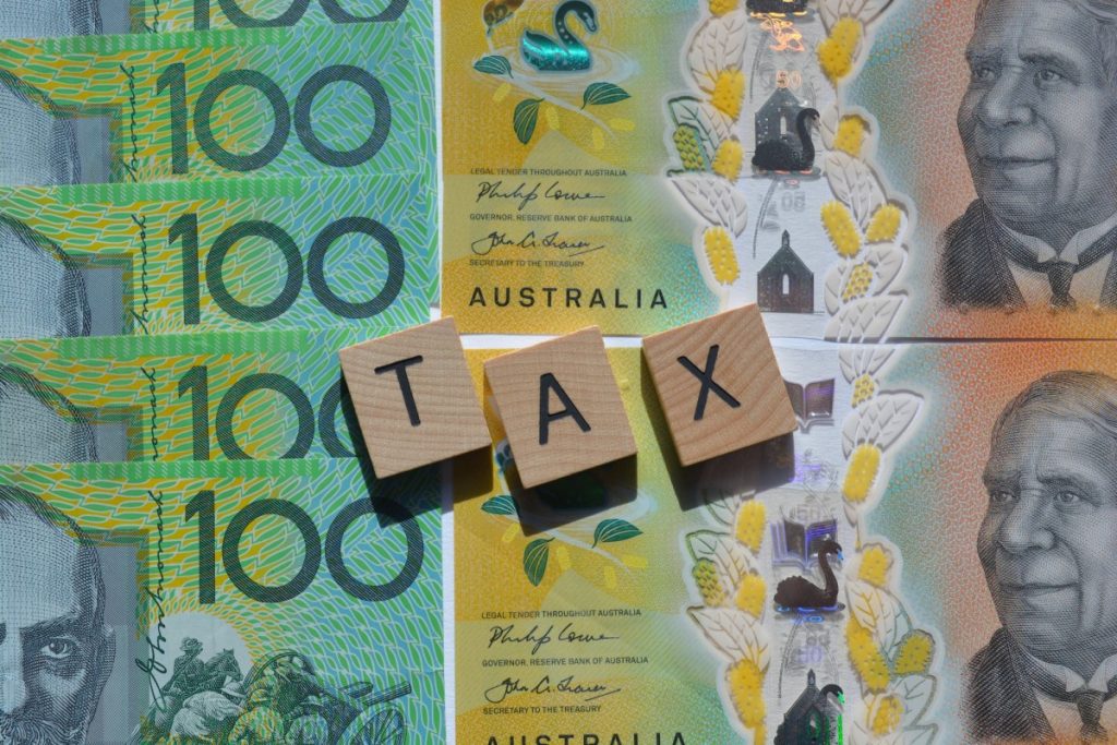 How to Set Up a Home Business to Avoid Tax Liability Australian currency with TAX tiles on top.