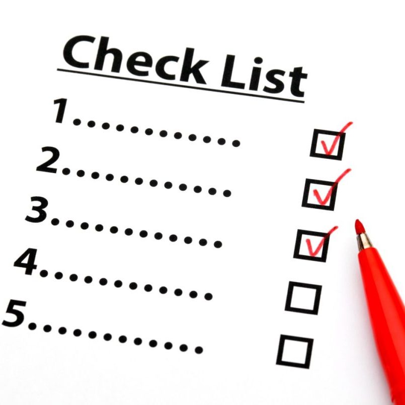white background with checklist and red pen that has checked off boxes